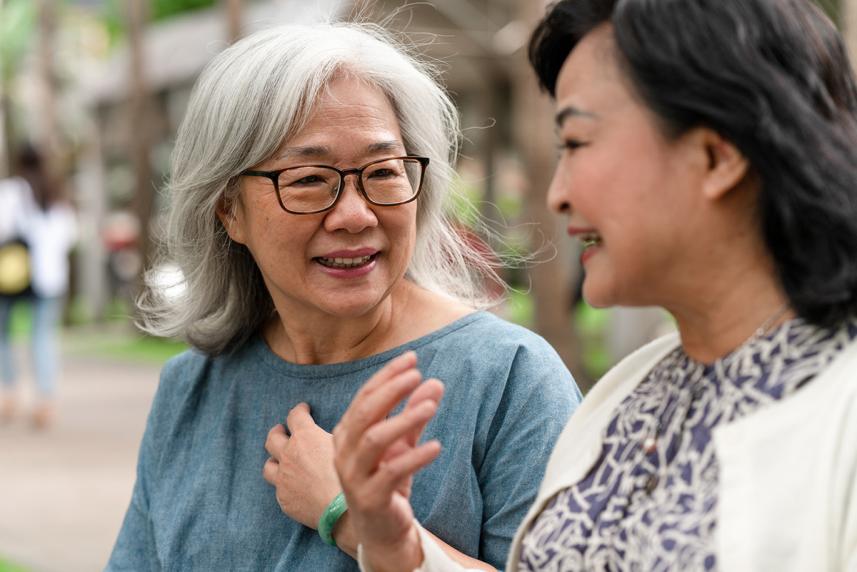Two senior friends talking about health screenings