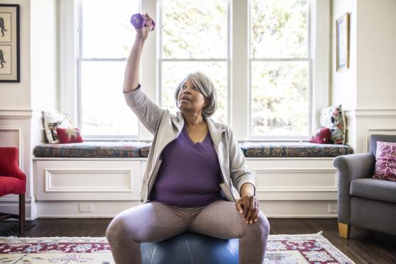 Older woman lifting weights to lose weight to manage diabetes